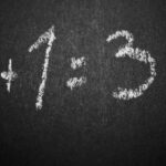 Mezzanine Addition - 1 + 1 = 3 Text on Black Chalkboard