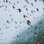 Glass-Balustrade - A car mirror with rain drops on it