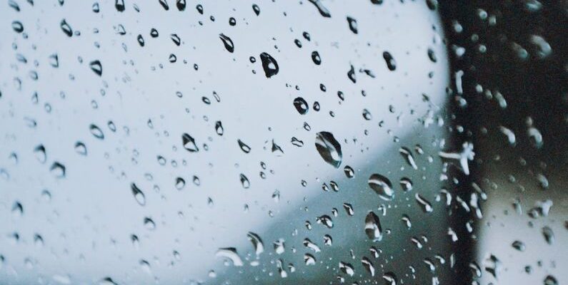 Glass-Balustrade - A car mirror with rain drops on it