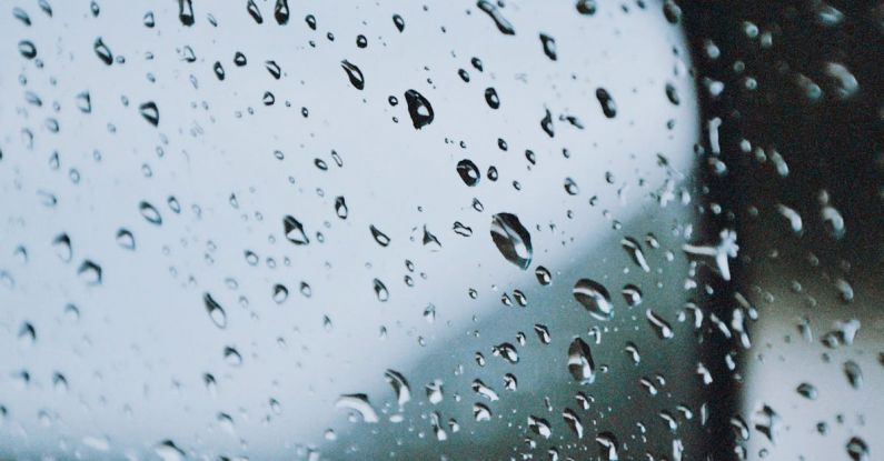 Glass-Balustrade - A car mirror with rain drops on it