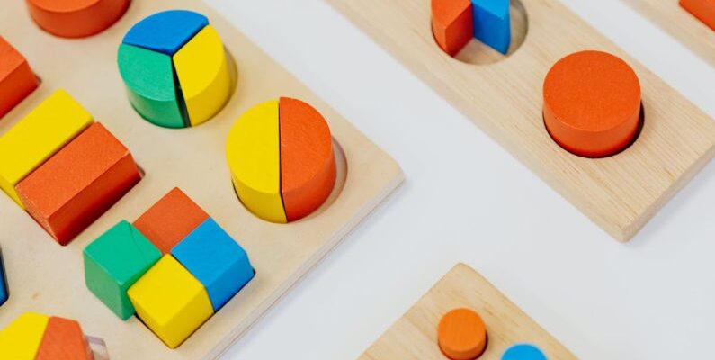 Nursery Playroom - Close-up Shot of Colorful Shapes on the White Table