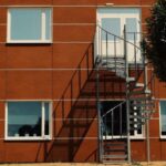 Staircase Designs - A tree is in front of a building with stairs