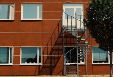 Staircase Designs - A tree is in front of a building with stairs