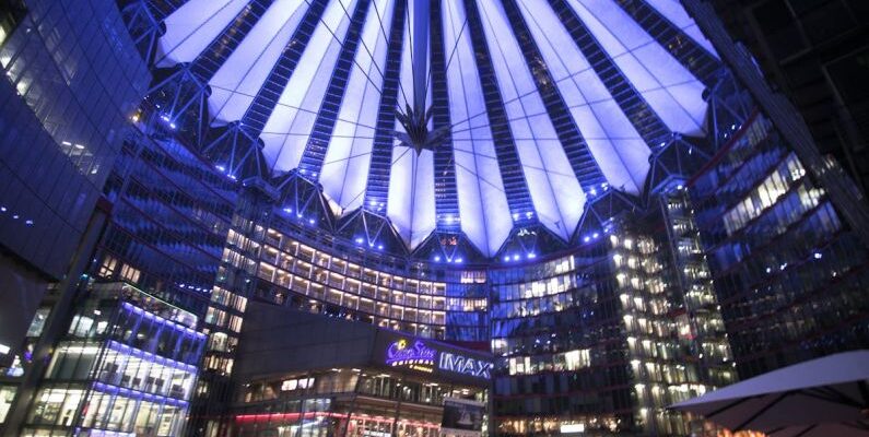 Modern Urban Aesthetic - Spectacular modern complex with illuminated glass roof at night