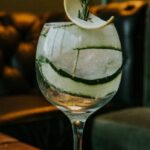 Modular Sofas - A gin and tonic on a wooden table with a slice of cucumber