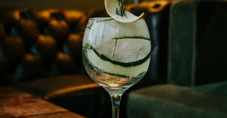 Modular Sofas - A gin and tonic on a wooden table with a slice of cucumber
