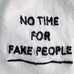Vertical Design - White cotton cloth with inscription on black font