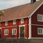 Sliding Panels - A red house with a white roof and a red door
