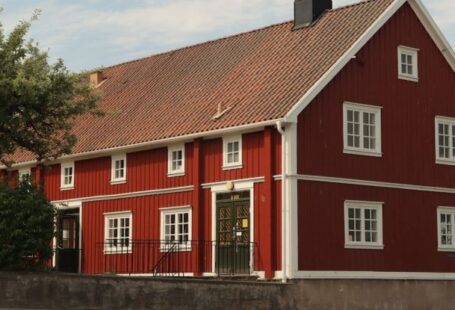 Sliding Panels - A red house with a white roof and a red door