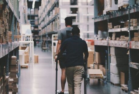 Storage - Men Going Around a Warehouse