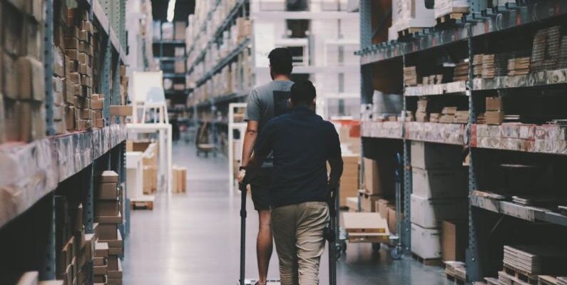 Storage - Men Going Around a Warehouse