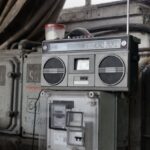 Storage System - Old fashioned cassette player placed in shabby garage near old industrial equipment