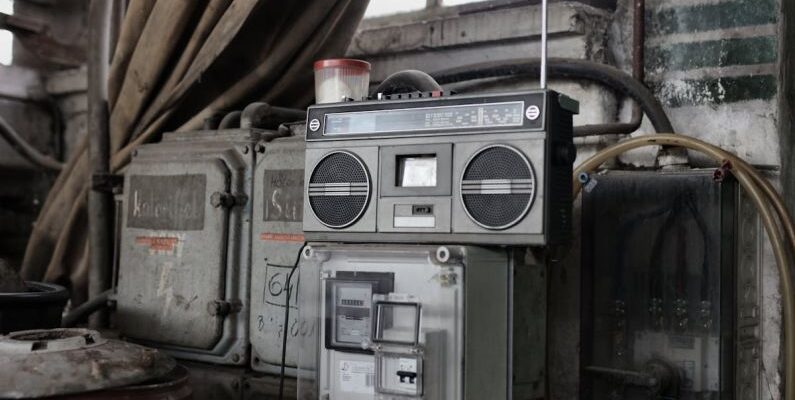 Storage System - Old fashioned cassette player placed in shabby garage near old industrial equipment