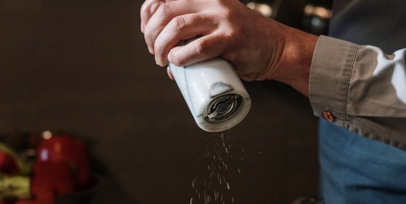 Spice Storage - Person in Blue Denim Jacket Holding White Ceramic Mug