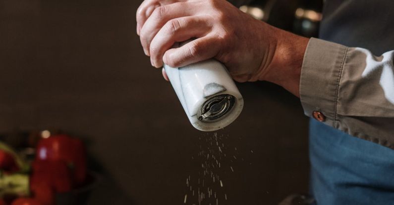 Spice Storage - Person in Blue Denim Jacket Holding White Ceramic Mug