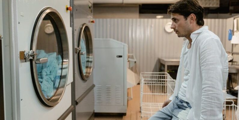 Smart Washing Machines - Man Looking at Washing Machines