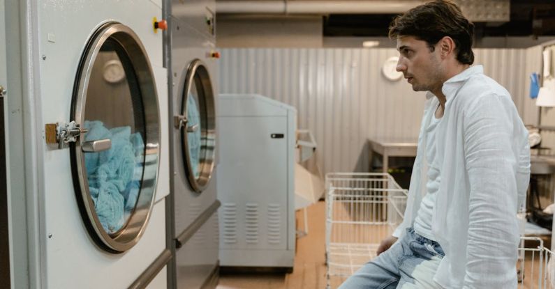 Smart Washing Machines - Man Looking at Washing Machines