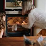 Oven - Woman in White Sweater Baking Cake