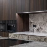 Induction Cooktops - Interior design of spacious stylish modern kitchen with induction stove and air extraction system with wooden cupboards