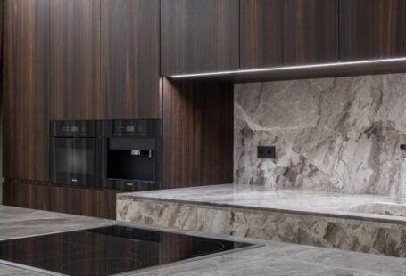 Induction Cooktops - Interior design of spacious stylish modern kitchen with induction stove and air extraction system with wooden cupboards