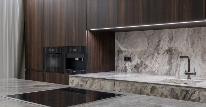 Induction Cooktops - Interior design of spacious stylish modern kitchen with induction stove and air extraction system with wooden cupboards