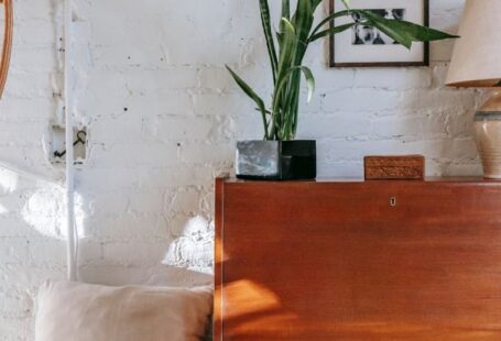 Loft Bedroom - Retro cabinet with potted plant near comfy bed
