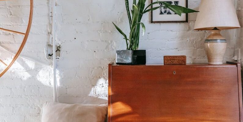 Loft Bedroom - Retro cabinet with potted plant near comfy bed