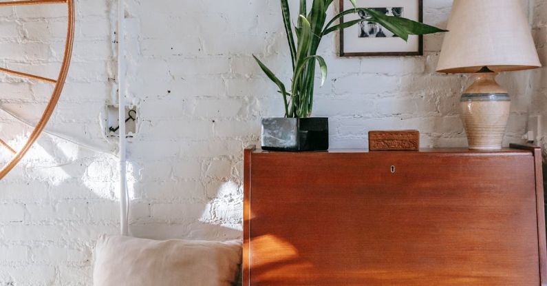 Loft Bedroom - Retro cabinet with potted plant near comfy bed