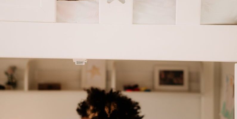 Loft Bed - A Boy Sitting Under the Bed