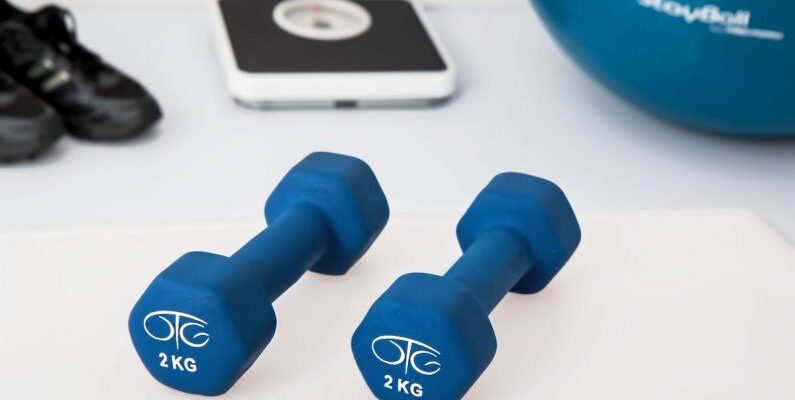 Home Gym - Two 2 Kg. Blue Hex Dumbbells on White Surface