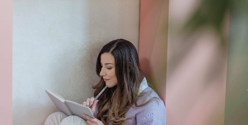 Task Lighting - Focused woman writing in notebook