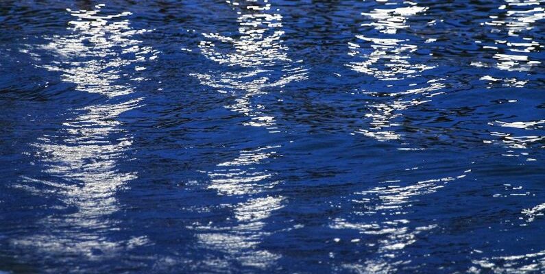 Light Reflective Surfaces - A reflection of a boat in the water