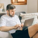Home Office - A Man Using a Laptop