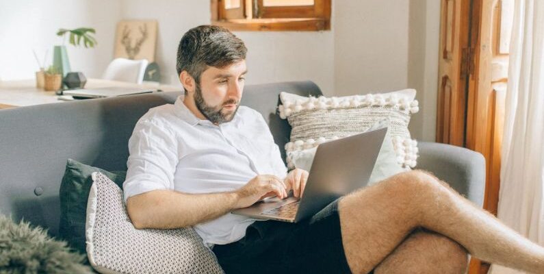 Home Office - A Man Using a Laptop