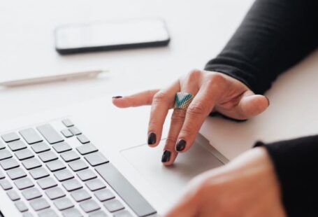 Smart Blinds - Crop female using touchpad on laptop in office